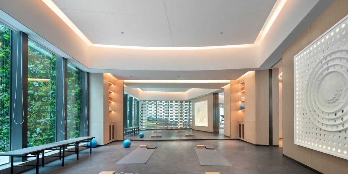 Modern yoga studio with large windows and mats.